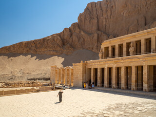 LUXOR, EGYPT : The Mortuary Temple of Hatshepsut at the Valley of the Queens, an impressive ancient Egyptian monument built into limestone cliffs, visited by travelers from around the world.