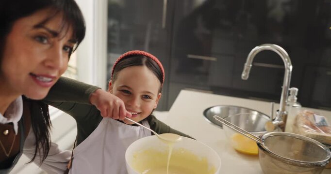 Happy mom, child and face with recording for baking, food vlog or online dessert recipe in kitchen. Mother, daughter or influencer in POV with batter for pancake tutorial or teaching junior baker