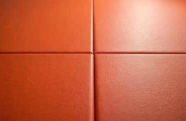 Close-up orange martial arts mat surface texture. Interlocking panels create a grid pattern on the floor. Dojo flooring for combat sports training and practice.