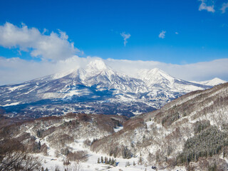 Beautiful snow-covered peaks of the Myoko mountain range on a sunny day (viewed from Madarao, Nagano, Japan)