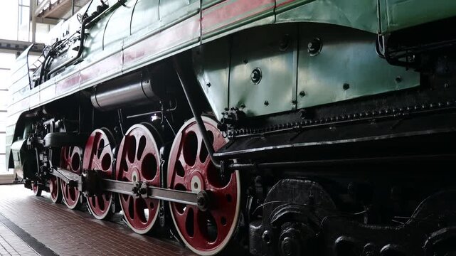 A large green train sitting on a train track, ready for departure