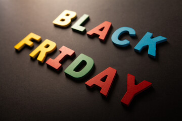 Black Friday word made of colorful wooden letters on black background. Black Friday concept.