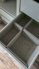 Obraz premium Top view of the drawers for storage of clothes. Sorting and organizing.