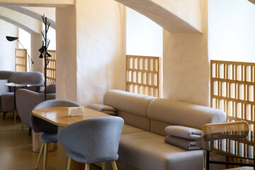 A Modern Minimalist Restaurant Interior Featuring Cozy and Inviting Seating Arrangements