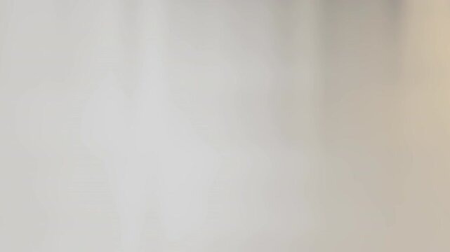 Soft, diffuse light on a pale, blurred background with warm beige tones and gentle reflections pale