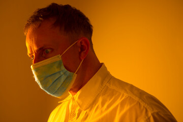 Closeup portrait of young man wearing face mask during coronavirus crisis in city