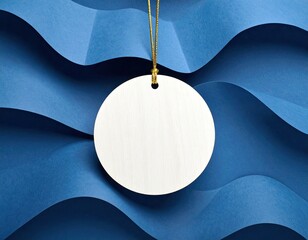Round tag on string, wavy blue paper background