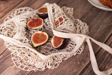 
Figs on wooden table, hand made bag, healthy and tasty food