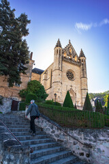 A man climbs the stairs to go to church in the town of Terrasson in the Dordogne region of France