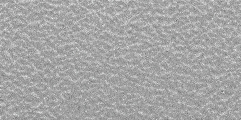 Fototapeta premium Detailed close-up of a rough metallic textured surface with a fine grain and subtle grey tones providing a robust industrial background element
