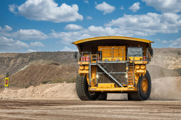 low angle view of mining truck driving on dirt road, in a diamond mine , open pit mine Africa, big tires © poco_bw