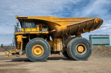 Obraz premium low angle view of mining truck driving on dirt road, in a diamond mine , open pit mine Africa, big tires
