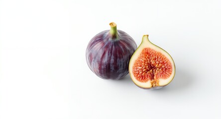 A whole and a cut fig fruit on a white background