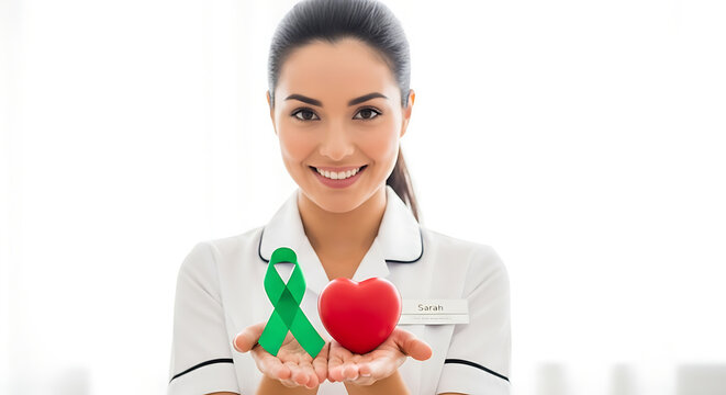 World mental health day nurse holding heart and green ribbon for health awareness and organ donation campaign support concept