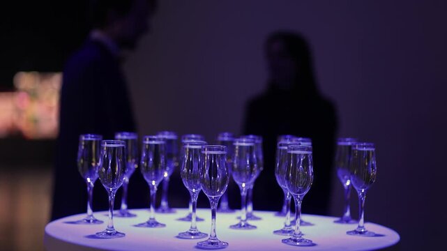 Champagne Toasting: Elegantly arranged glasses of champagne grace a table, a silent invitation to a festive event, bathed in a soft, ambient glow, promising a memorable gathering.