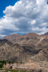 Vast mountain range under cloudy sky with valley below