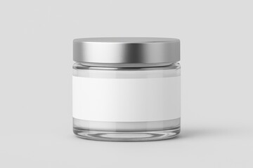 Clear glass cosmetic or food jar with a blank white label and silver lid, on a light background.