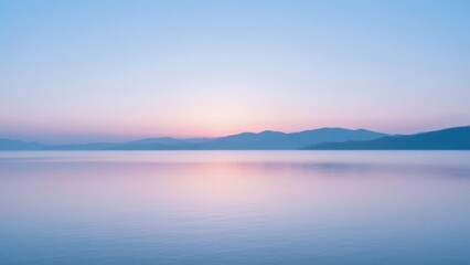 Obraz premium Sunset over calm lake with mountains