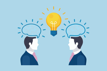 Two businessmen collaborating to generate a bright new idea symbolized by a glowing lightbulb above their heads
