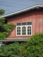 window with red shutters in the garden