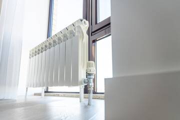 White big radiator near window in modern room
