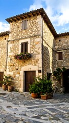 Naklejka premium Quaint stone house in a sun-drenched European town square