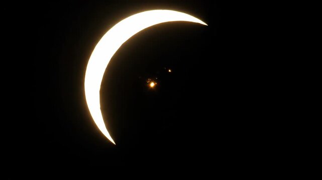 Partial solar eclipse with bright crescent dark sky celestial phenomenon cosmic event