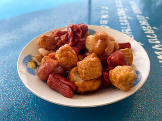 fried meatball and sausage with sauce on plate