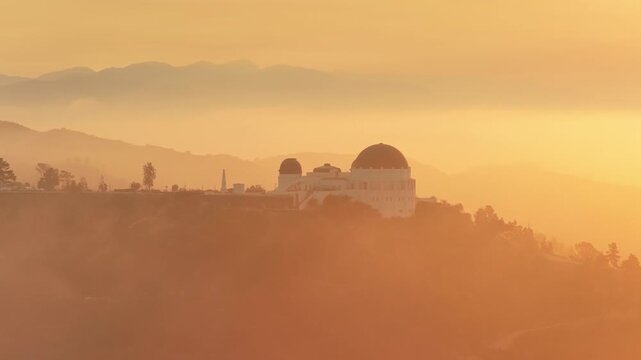Los Angeles, California, USA - JUNE, 2025: Experience the stunning and beautiful sunrise view of Griffith Observatory, which is beautifully surrounded by fog in the incredible Griffith Park,California