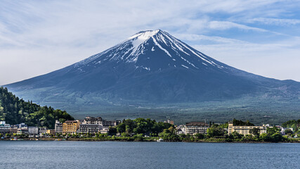 Scenic view of Mount Fuji over lake kawaguchiko Japan during springtime with lush foliage
