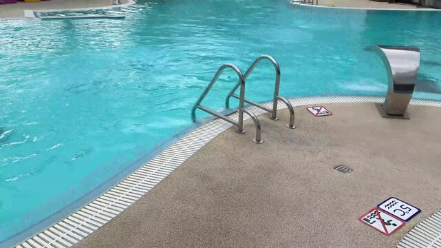 relaxing empty swimming pool with clear turquoise