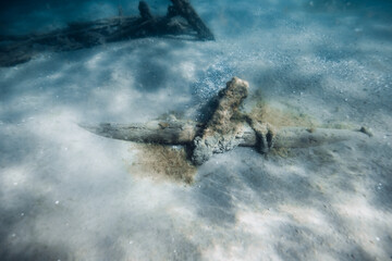 Wreckship underwater on sandy sea bottom