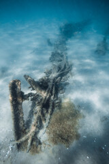 Underwater sea with wreck ship on sandy sea bottom