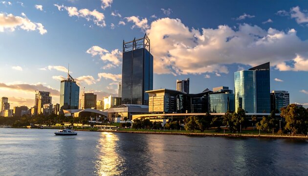 City skyline by the water at sunset with scattered clouds
