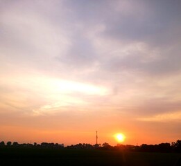 sunset in the afternoon, yellow sky and beautiful white clouds