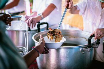 The hands of the hungry are asking for food from the donor,Out to the Homeless and Hungry