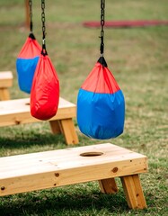 Hanging Punching Bags Over Wooden Cornhole Boards