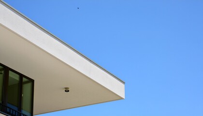 Fototapeta premium Minimalist modern white building against clear blue sky