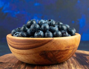 Wooden bowl filled with ripe blueberries on a wooden surface