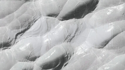 Close up of a white painted wall with a rough texture and uneven surface