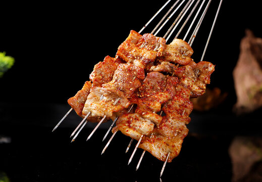 Chinese meat barbecue close up on black background:pork belly or wuhuarou