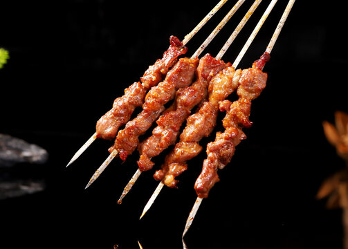 Chinese meat barbecue close up on black background:Lamb kebabs