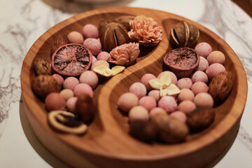 air freshener, ball-shaped and dried herbs on a wooden plate
