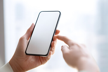 Close up of woman's hand holding and touching blank screen of modern smartphone. Technology concept