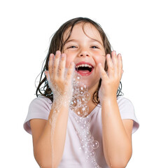 Joyful little girl playing with soap bubbles and smiling widely