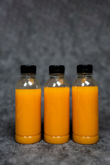 Sour orange juices in three plastic bottles with black lid