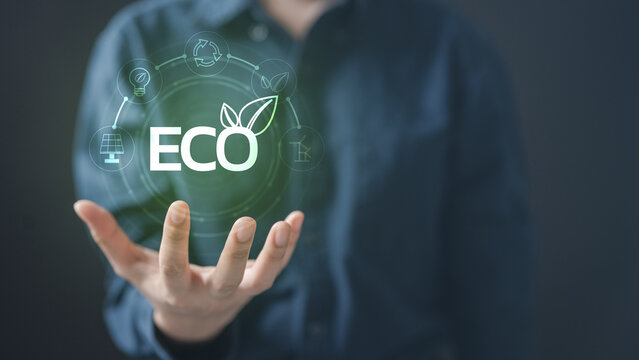 Open hand holding glowing ECO icon with green energy symbols, representing renewable energy, solar power, cost savings, ROI, and sustainable solutions for environmental protection.