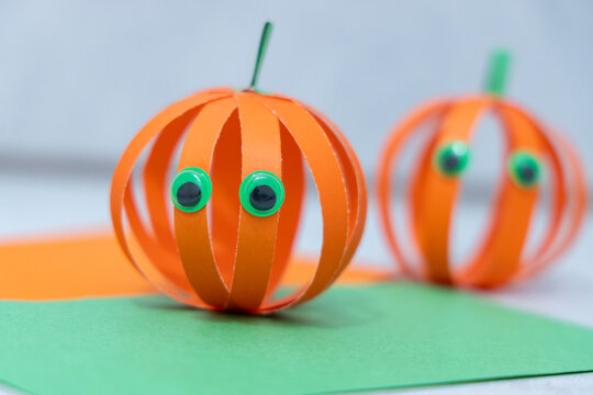 Step 7 of 7 making paper pumpkin for Halloween. Finished paper pumpkin craft for Halloween, handmade decoration ready for spooky seasonal celebration