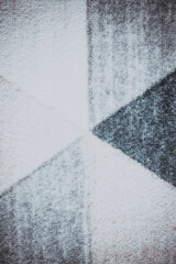 The backdrop is adorned with intricate, abstract patterns in a variety of hues.