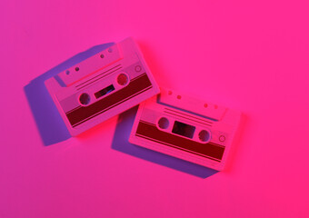Fototapeta premium Audio cassettes in neon light. Retro wave, 80s